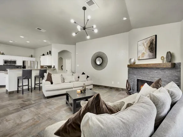 a living room with furniture and kitchen view