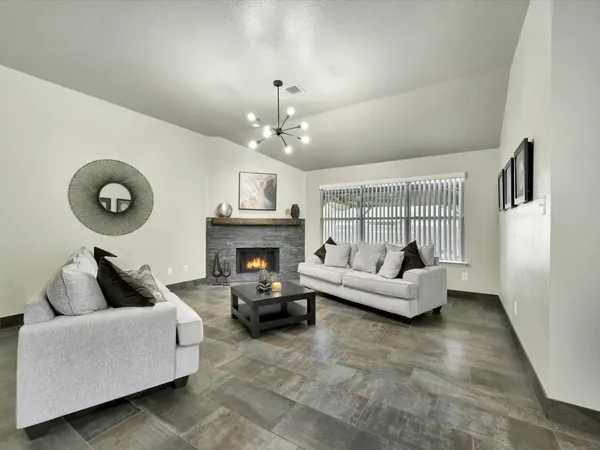 a living room with furniture and a fireplace