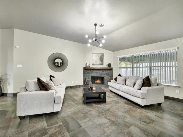 a living room with furniture and a fireplace