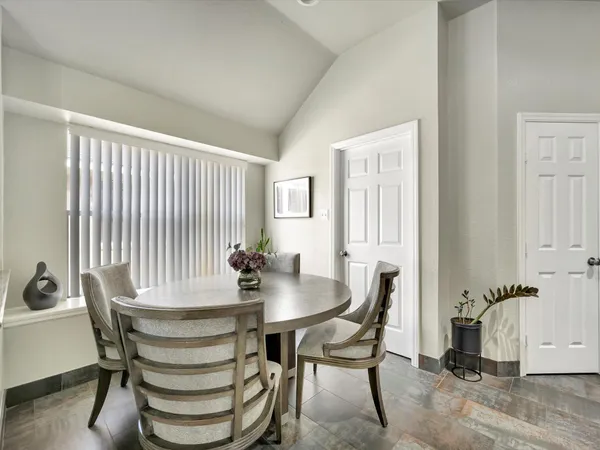 a view of a dining room with furniture and window