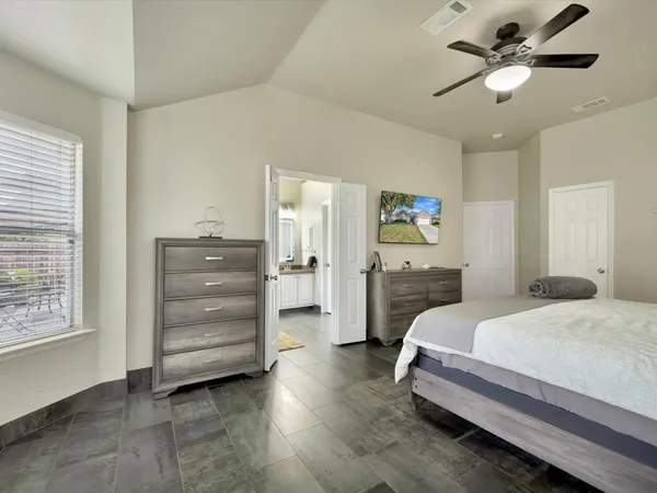 a bedroom with a bed and ceiling fan