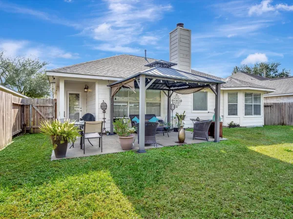 a view of a house with a yard porch and sitting area