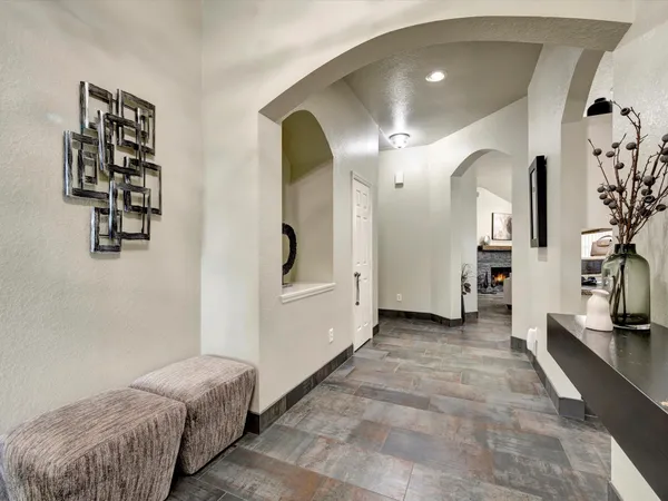 a spacious bedroom with a bed a mirror and desk