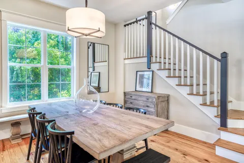 a view of a dining room with furniture window and wooden floor