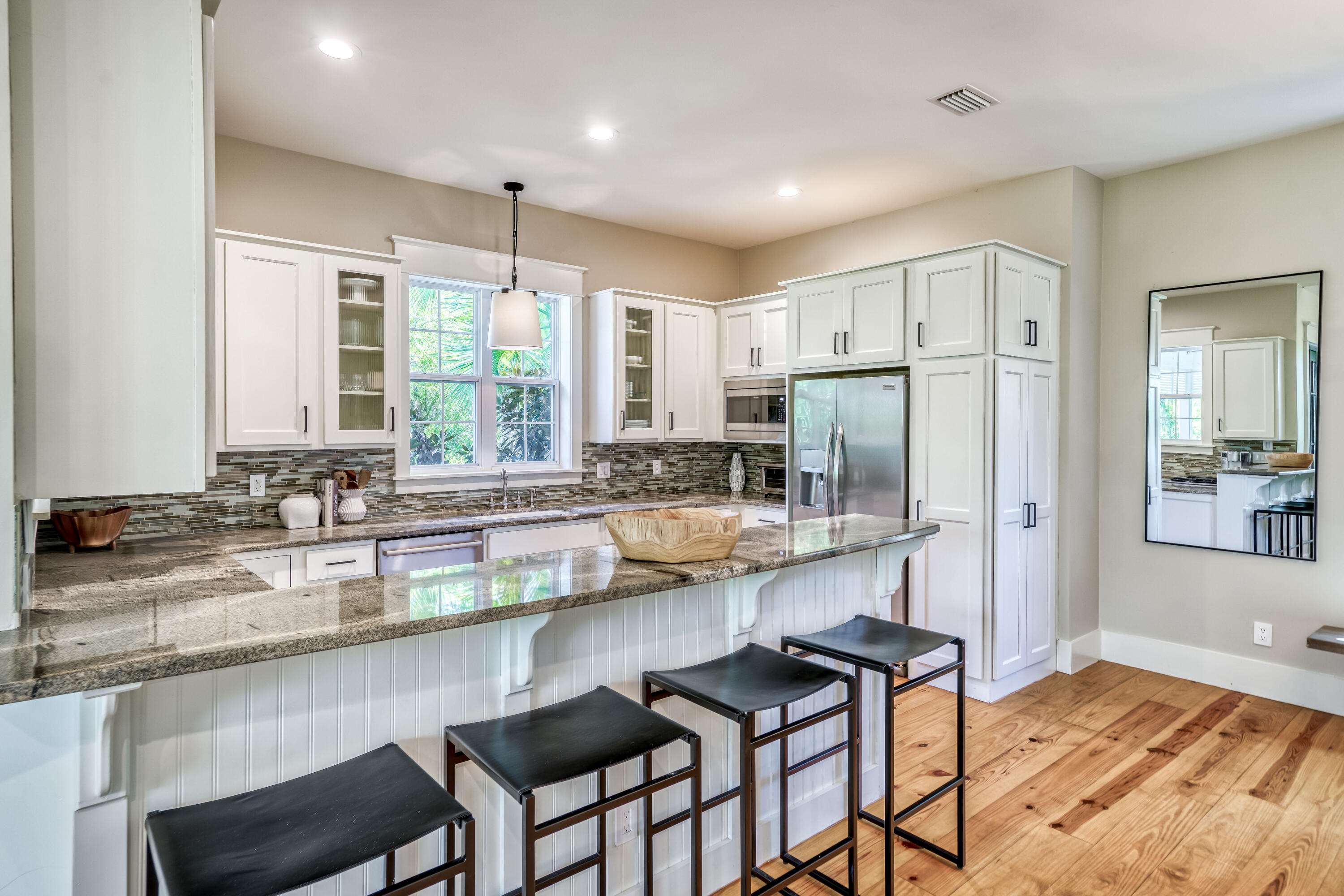 47 Hammock Lane Santa Rosa Beach, FL 32459 - Photo 14 of 51 a kitchen with stainless steel appliances granite countertop a stove a sink a refrigerator white cabinets and wooden floor