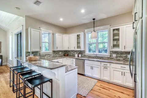 a kitchen with counter top space appliances and windows