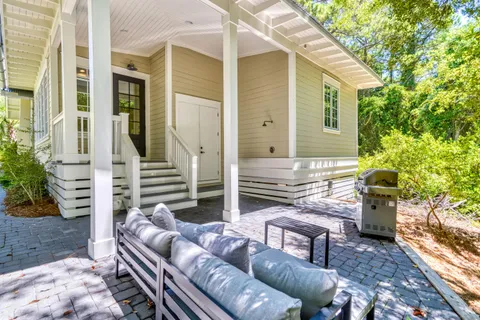 a backyard of a house with fire pit and outdoor seating