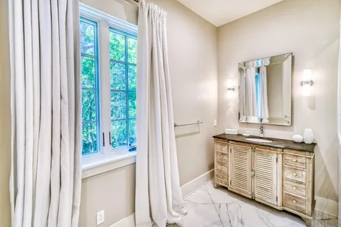 a spacious bathroom with a granite countertop sink mirror and shower