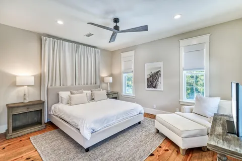 a bedroom with a large bed and a chandelier