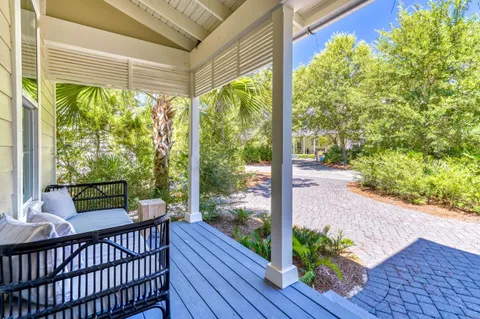 a balcony with furniture and wooden floor