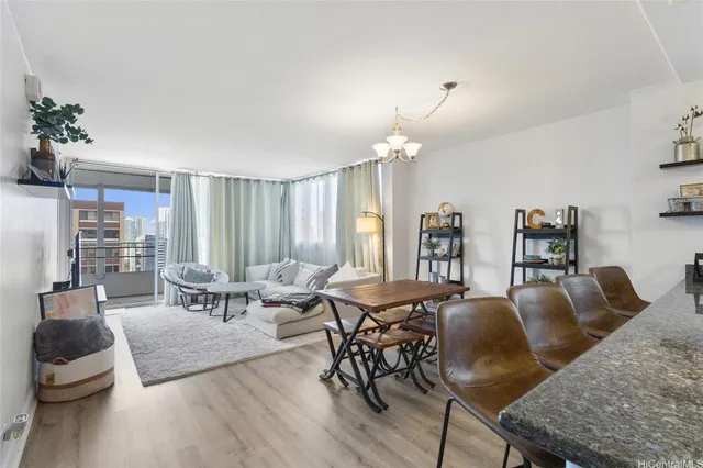 a living room with furniture and a chandelier