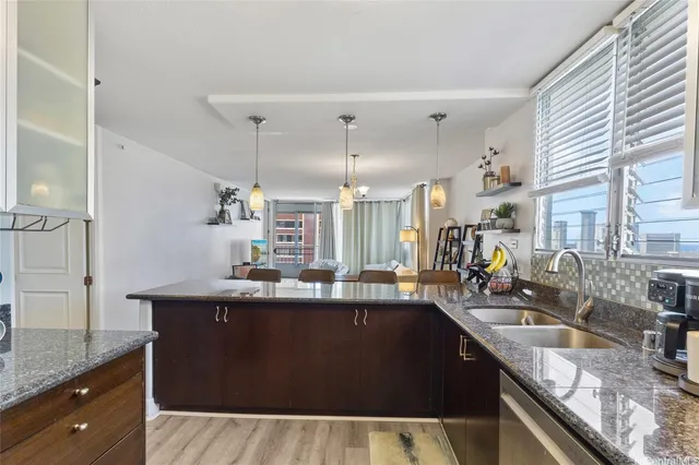 a kitchen with granite countertop a sink and cabinets