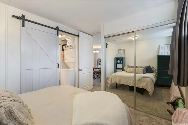 a bed room with a bed and a large mirror