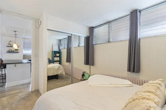 a bedroom with a bed and a large window