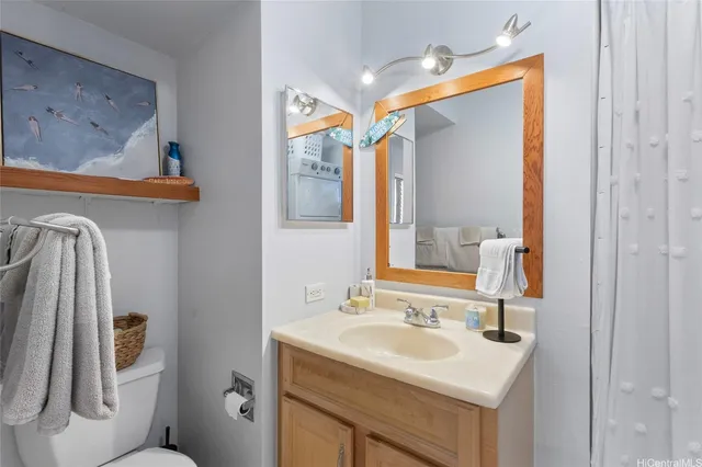a bathroom with a sink toilet and mirror