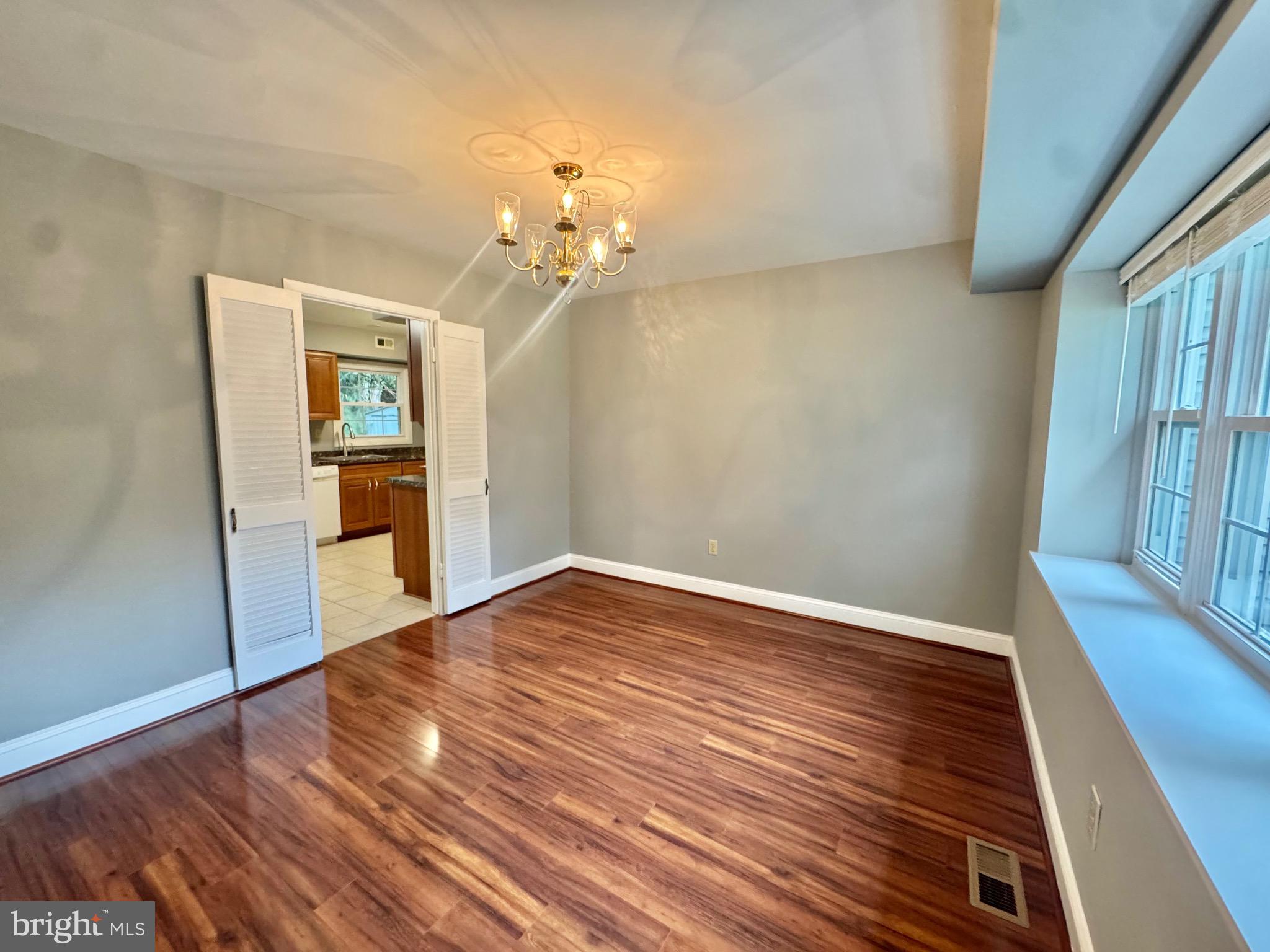 4908 Rocky Spring Lane Bowie, MD 20715 - Photo 8 of 36 wooden floor in an empty room with a window