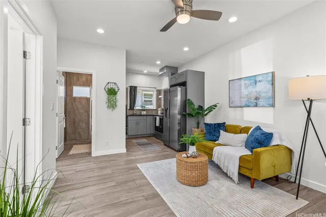 a living room with furniture and wooden floor