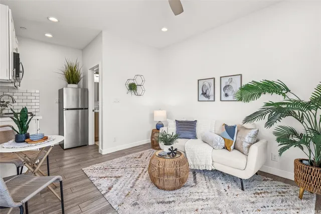a living room with furniture and a potted plant
