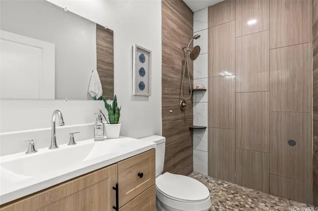 a bathroom with a sink a toilet and shower