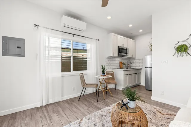 a kitchen with furniture wooden floor and a window