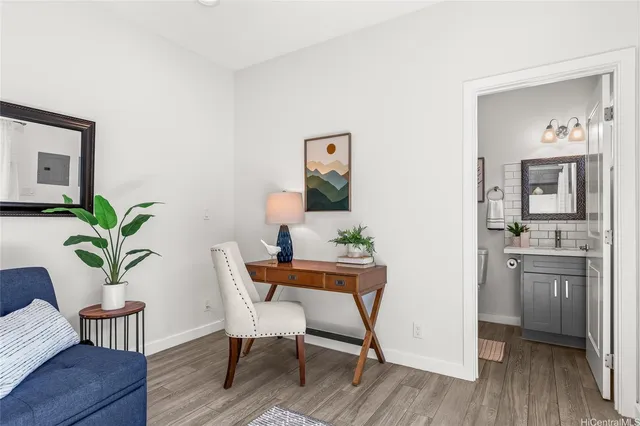 a workspace room with furniture and wooden floor