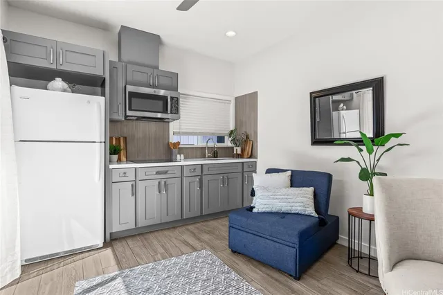 a kitchen with a refrigerator sink and white cabinets