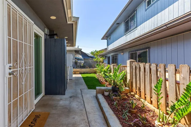 a view of a house with a wooden fence