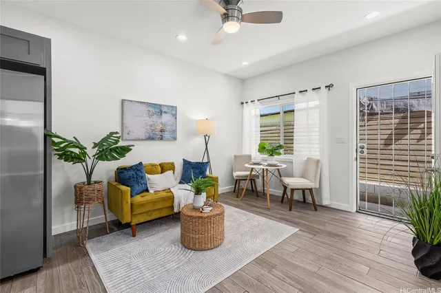 a living room with furniture and a potted plant