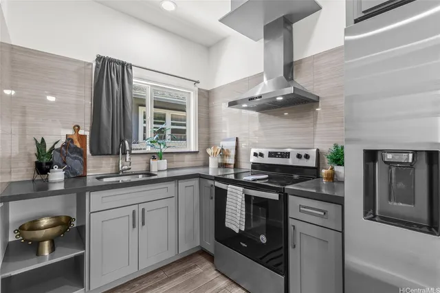 a kitchen with stainless steel appliances a sink stove and cabinets