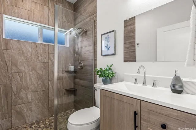 a bathroom with a sink a toilet and shower