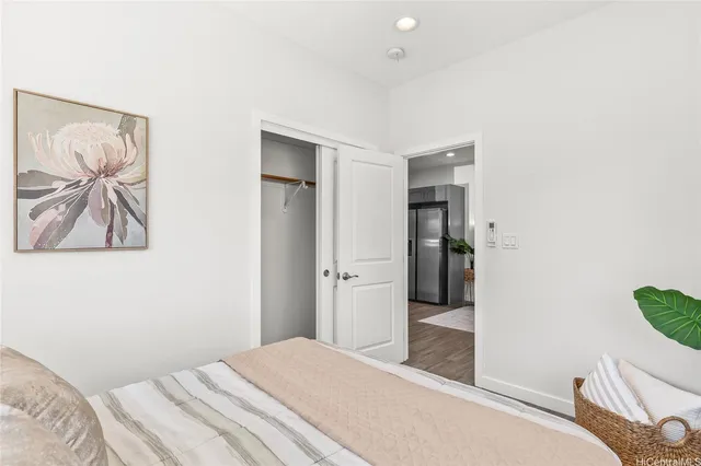 a bedroom with a bed and a painting on the wall