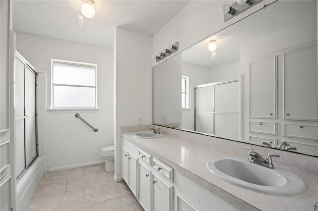 a bathroom with 2 sink and a mirror