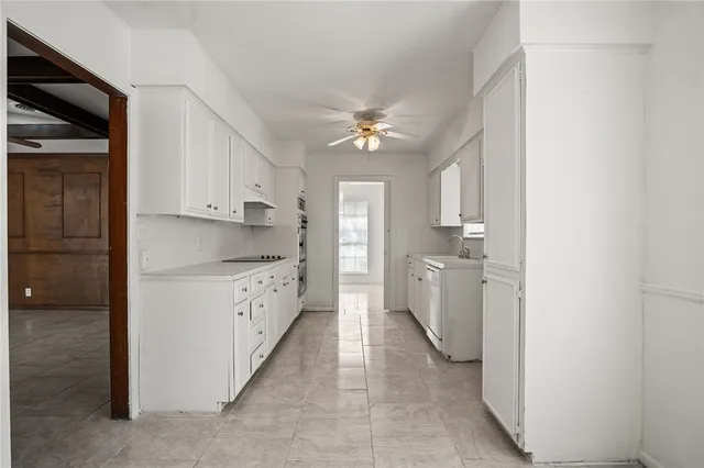 a kitchen with white cabinets and white appliances