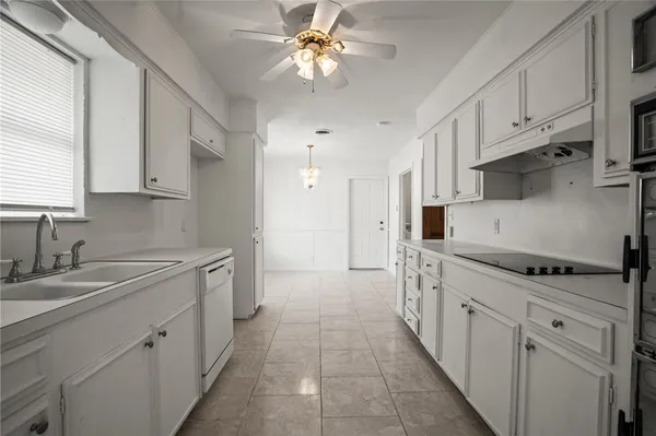 a kitchen with stainless steel appliances granite countertop a sink and cabinets