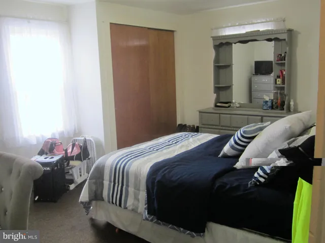 a bedroom with a bed and a mirror