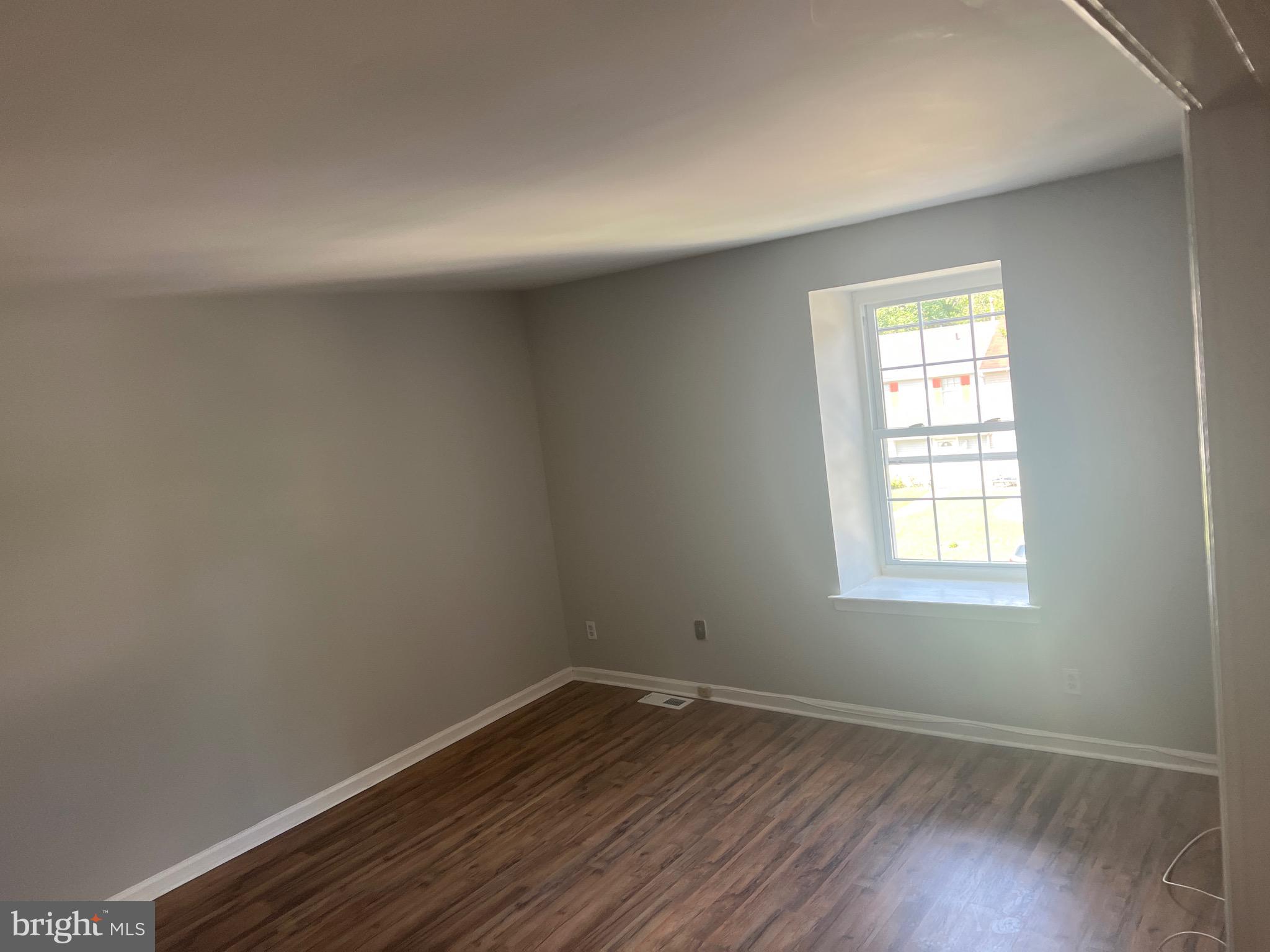 26 Hampton Gate Drive, Unit B Sicklerville, NJ 08081 - Photo 13 of 17 an empty room with wooden floor and windows