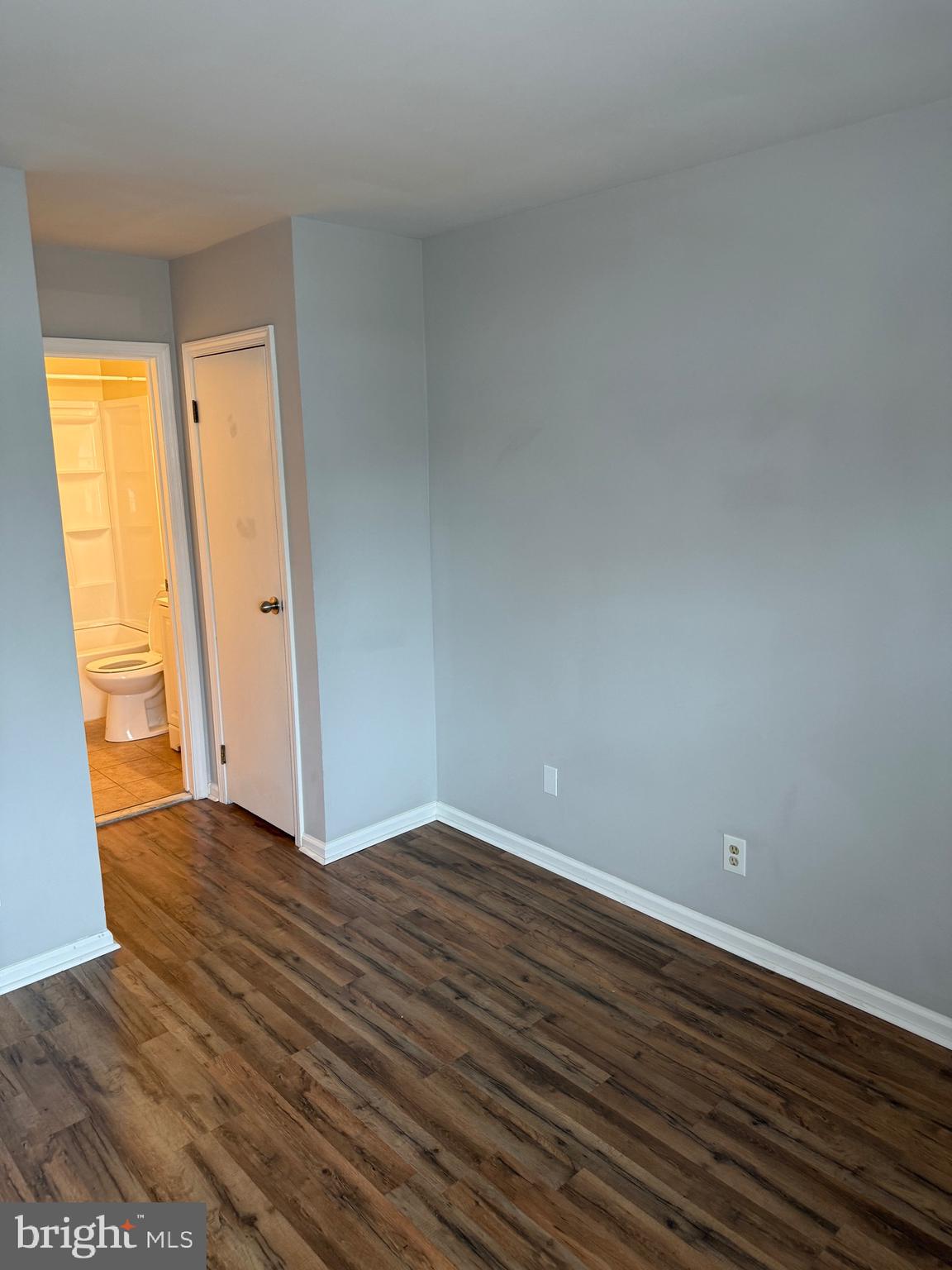 26 Hampton Gate Drive, Unit B Sicklerville, NJ 08081 - Photo 14 of 17 a view of an empty room with wooden floor and a window