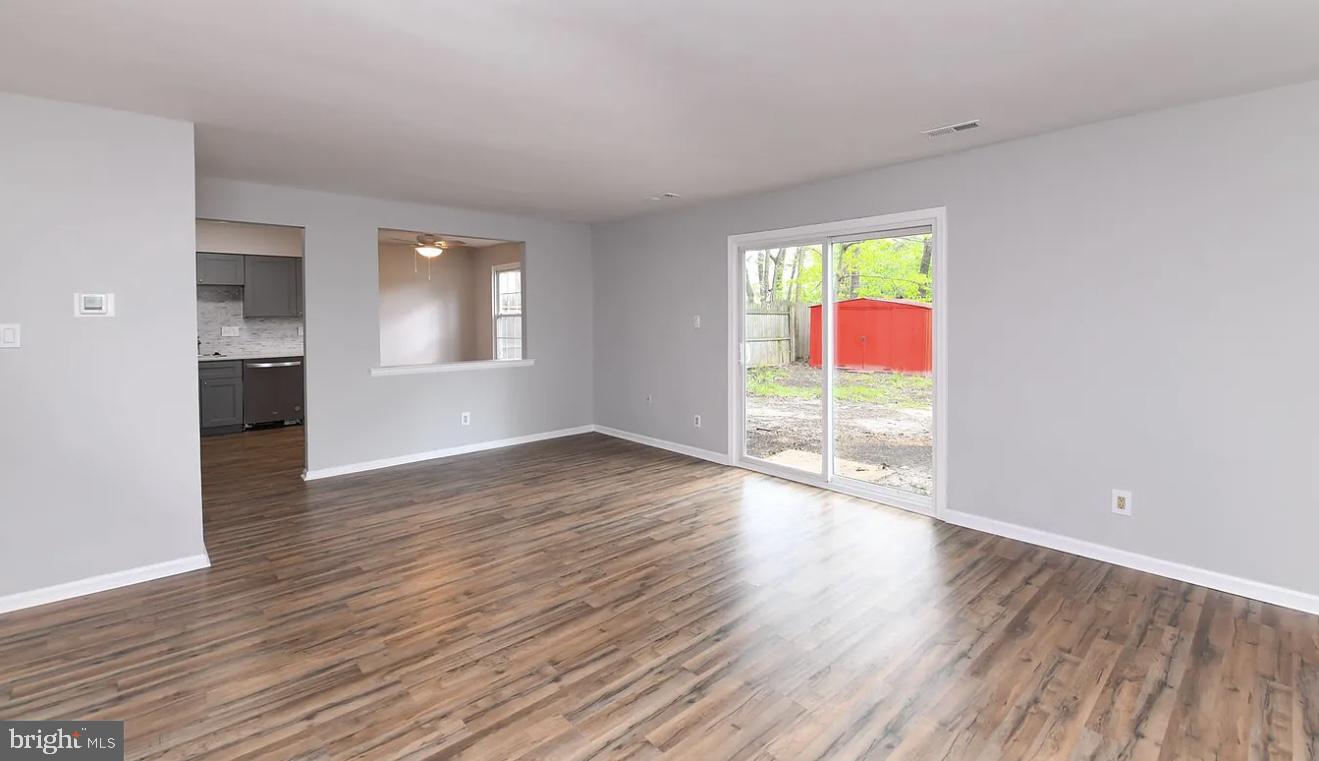 26 Hampton Gate Drive, Unit B Sicklerville, NJ 08081 - Photo 4 of 17 an empty room with wooden floor and windows