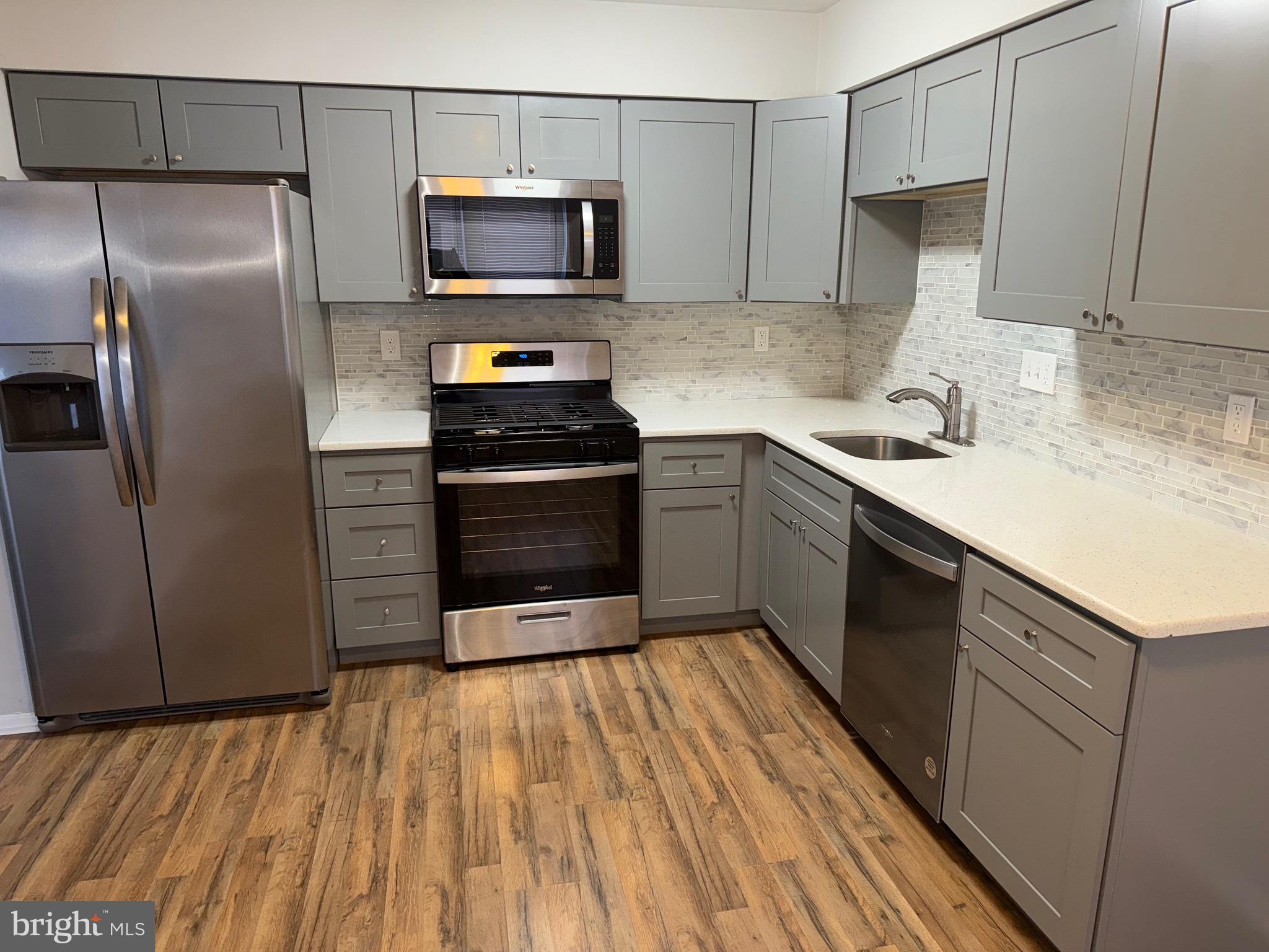 26 Hampton Gate Drive, Unit B Sicklerville, NJ 08081 - Photo 7 of 17 a kitchen with a sink and steel stainless steel appliances