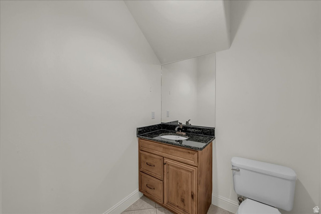 691 Rainier Drive St. George, UT 84770 - Photo 14 of 24 Bathroom featuring vanity, light tile patterned floors, and lofted ceiling