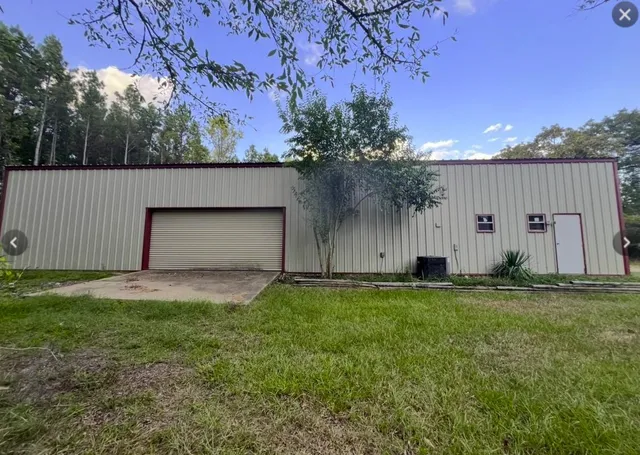 a backyard of house with garden and trees