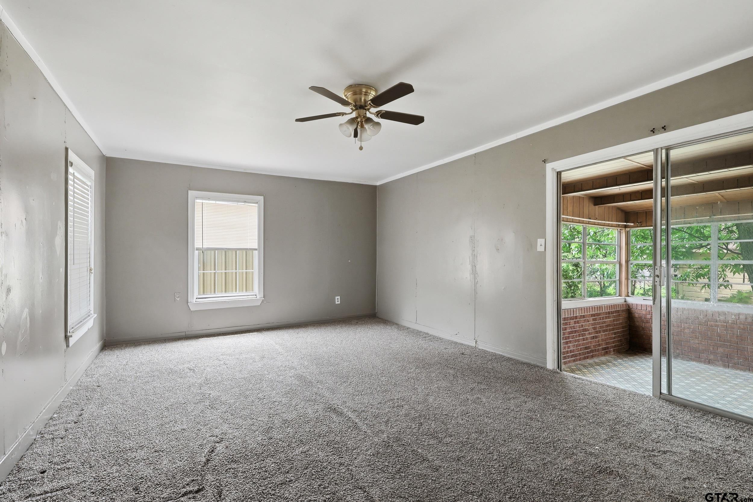 405 Rusk Street Pittsburg, TX 75686 - Photo 15 of 33 a view of a livingroom with a ceiling fan and window