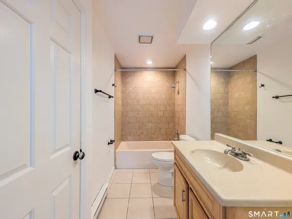 a bathroom with a sink toilet tub and shower