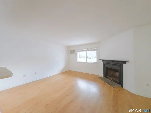 a view of empty room with a fireplace