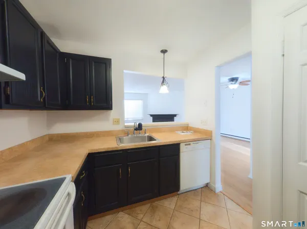 a kitchen with a sink a stove a refrigerator and cabinets
