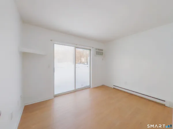 an empty room with a empty space and a window