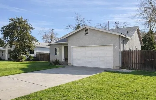 a view of a house with a yard and garage
