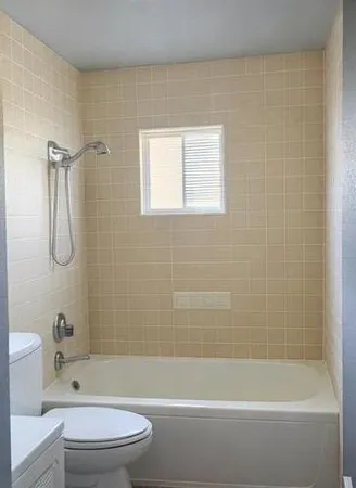 a bathroom with a bathtub and a toilet