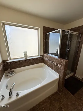 a bathroom with a glass shower door and a glass door