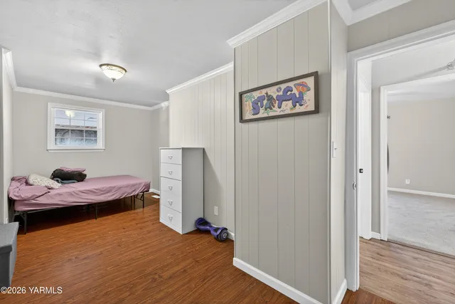 a view of a hallway with wooden floor and entryway